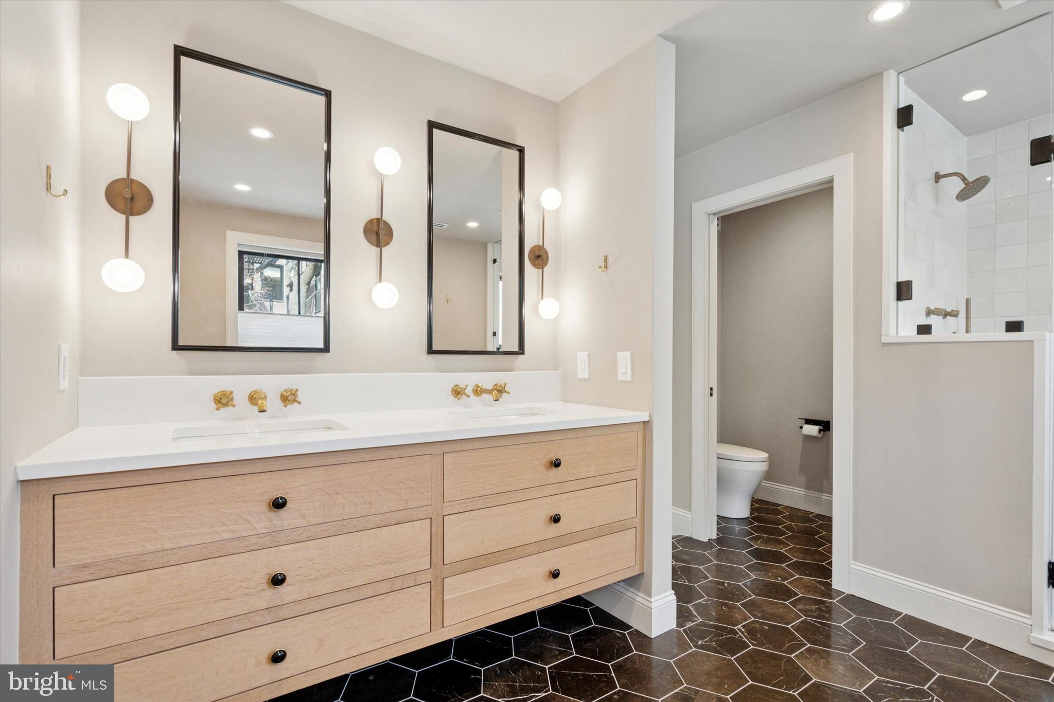 1725-27 Addison Street Philadelphia, PA 19146 - Photo 21 of 43 a bathroom with a sink a toilet and a mirror
