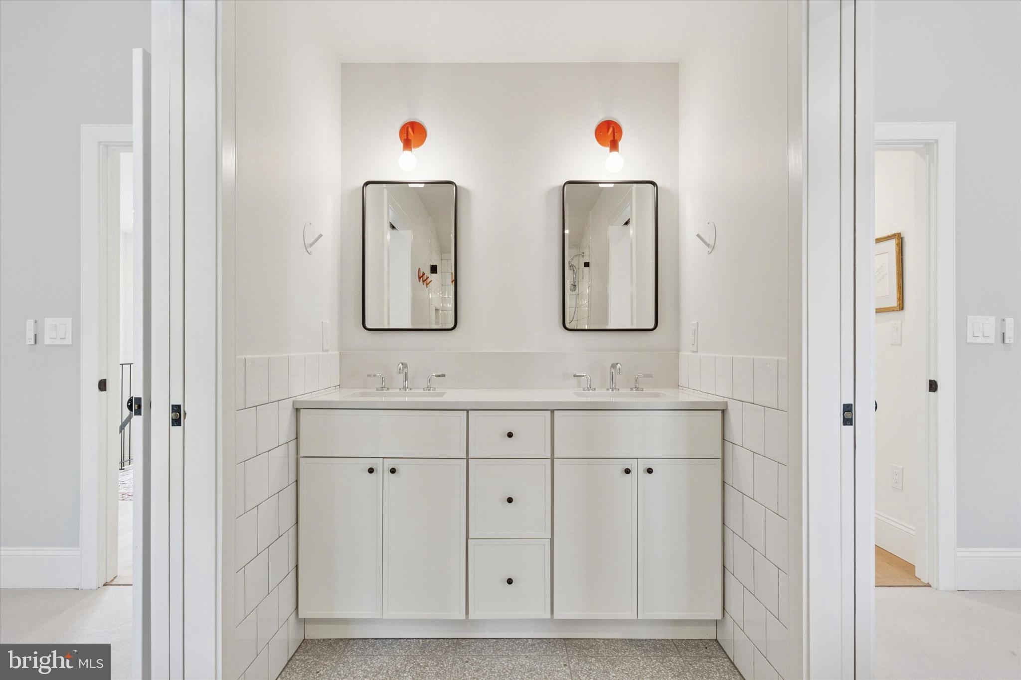 1725-27 Addison Street Philadelphia, PA 19146 - Photo 28 of 43 a bathroom with double vanity sink and a mirror