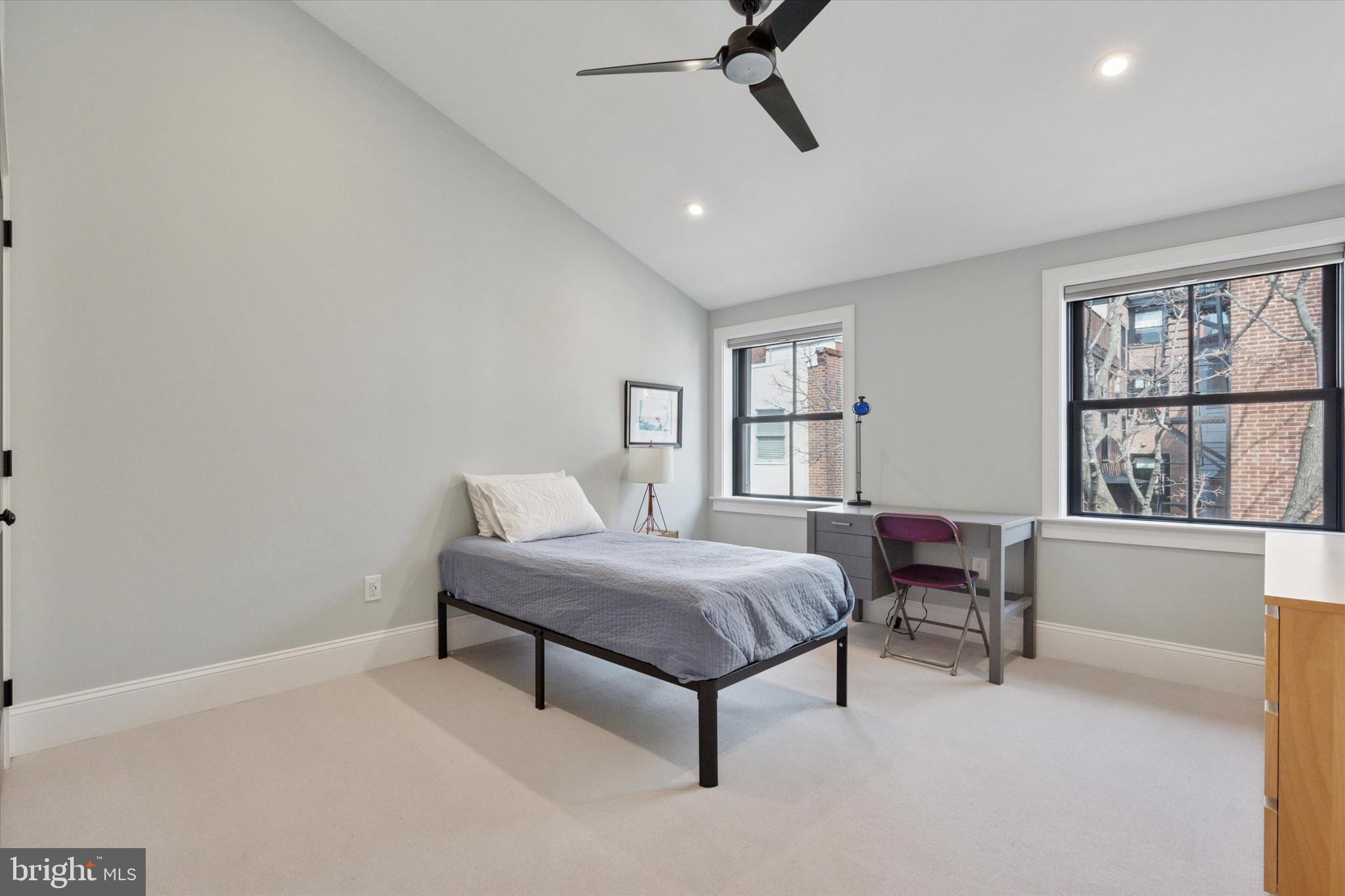 1725-27 Addison Street Philadelphia, PA 19146 - Photo 30 of 43 a bedroom with a bed lamps and window