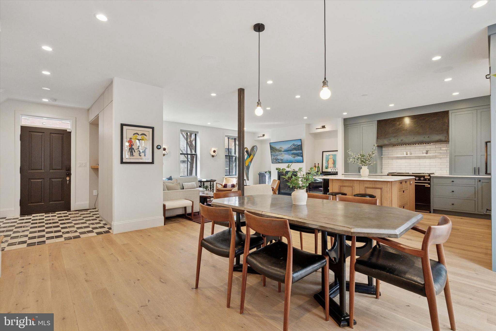 1725-27 Addison Street Philadelphia, PA 19146 - Photo 3 of 43 a dining room with stainless steel appliances a dining table chairs and couches