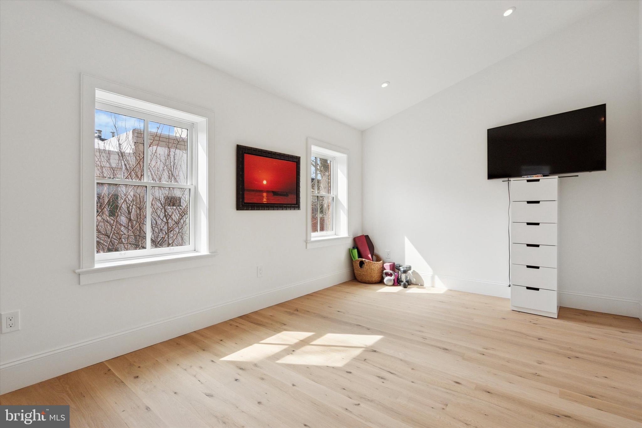1725-27 Addison Street Philadelphia, PA 19146 - Photo 32 of 43 a view of a livingroom with workspace and a flat screen tv