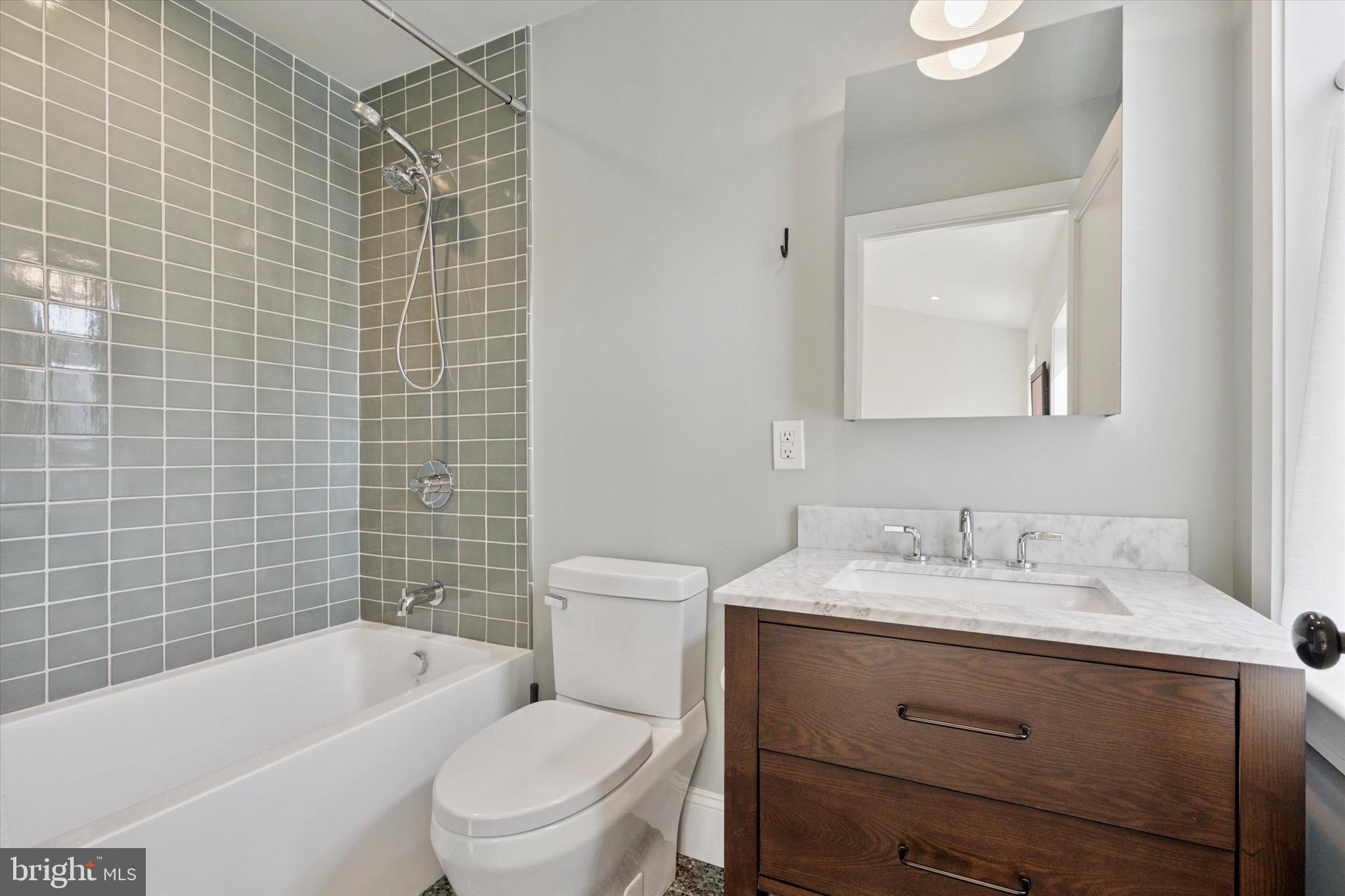 1725-27 Addison Street Philadelphia, PA 19146 - Photo 33 of 43 a bathroom with a sink toilet vanity and bathtub