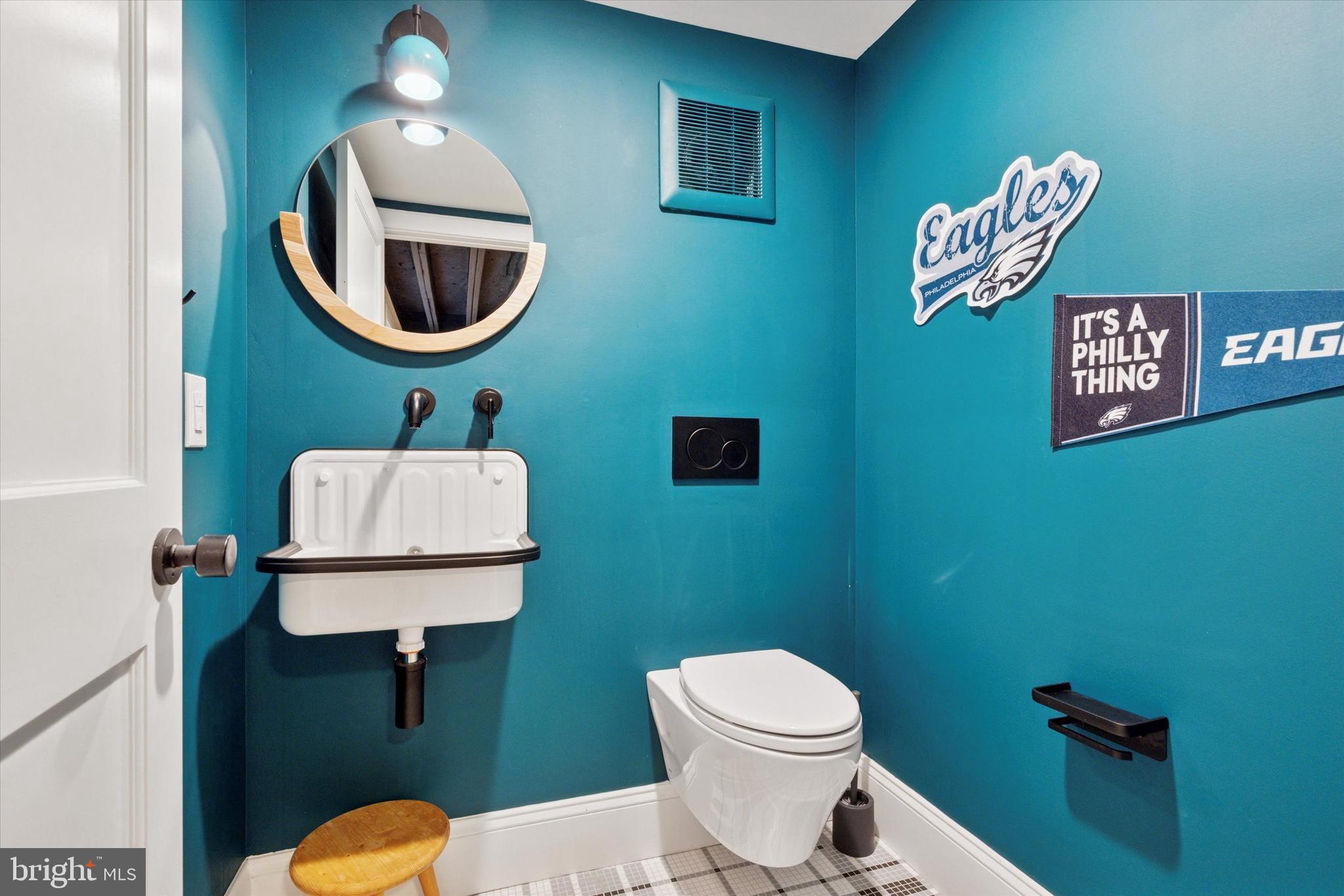 1725-27 Addison Street Philadelphia, PA 19146 - Photo 36 of 43 a bathroom with a toilet sink and mirror