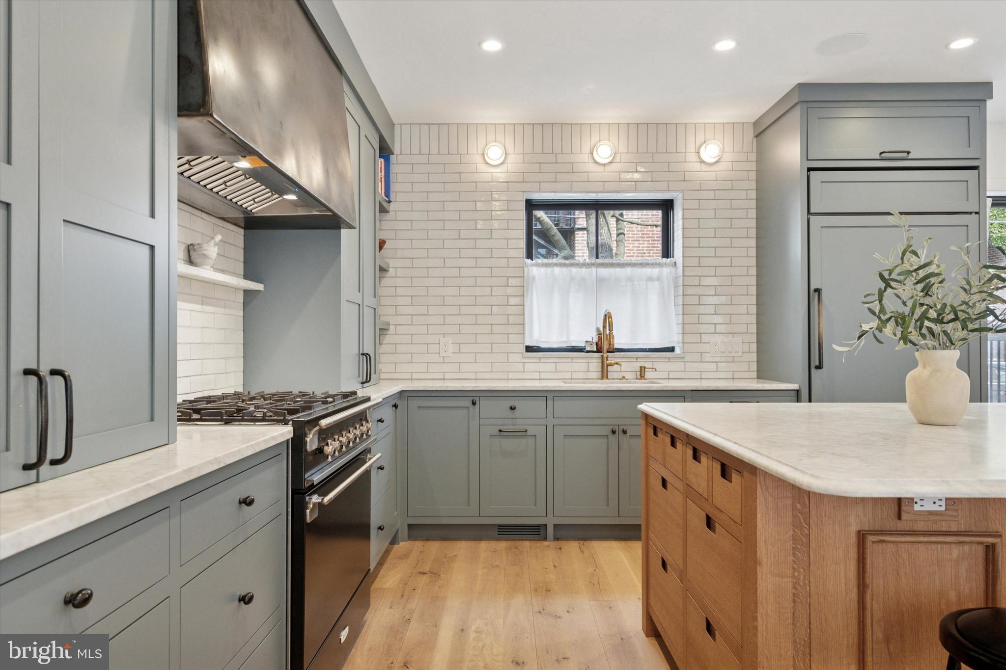 1725-27 Addison Street Philadelphia, PA 19146 - Photo 8 of 43 a kitchen with a sink stove and cabinets