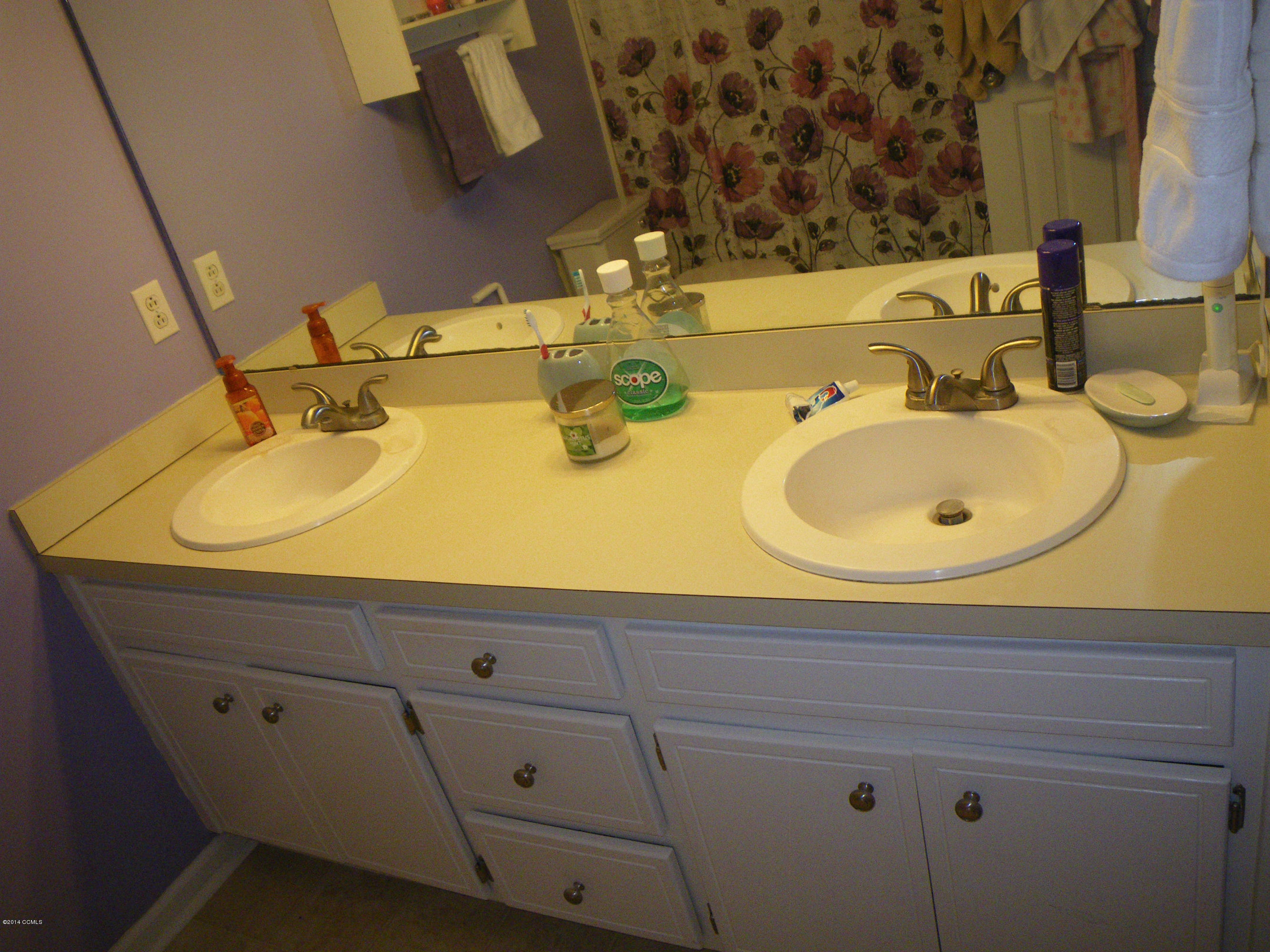 3013 Old Gate Road Morehead City, NC 28557 - Photo 10 of 16 Owner's suite with double sink vanity on first floor of house.