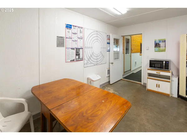 a kitchen with granite countertop a sink a refrigerator a stove and white cabinets