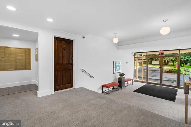 a bedroom with furniture and large windows