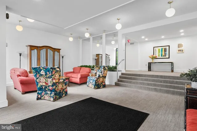 a lobby with furniture and a chandelier