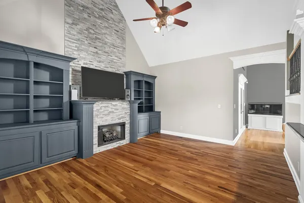 a kitchen with kitchen island granite countertop stainless steel appliances and wooden cabinets