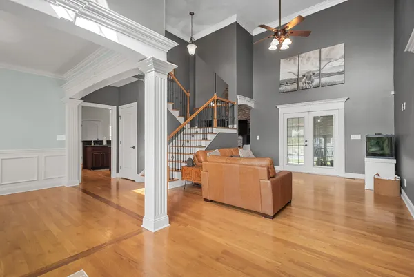 a view of a room with window wooden floor and front door