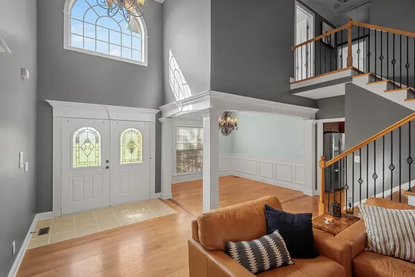 a view of a livingroom with wooden floor and stairs