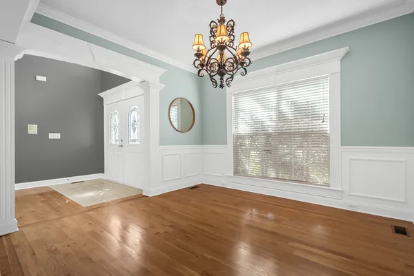 a view of a livingroom with furniture wooden floor and windows