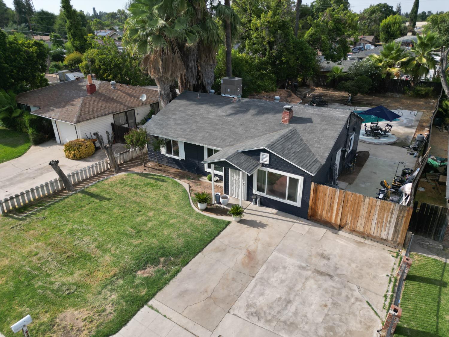 an aerial view of a house with swimming pool garden and patio