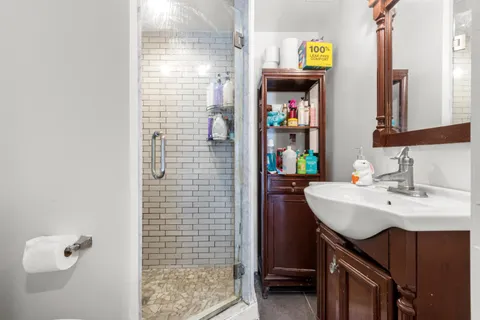 a bathroom with a sink a toilet and shower