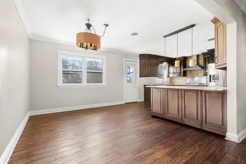 a kitchen with wooden floors and cabinets