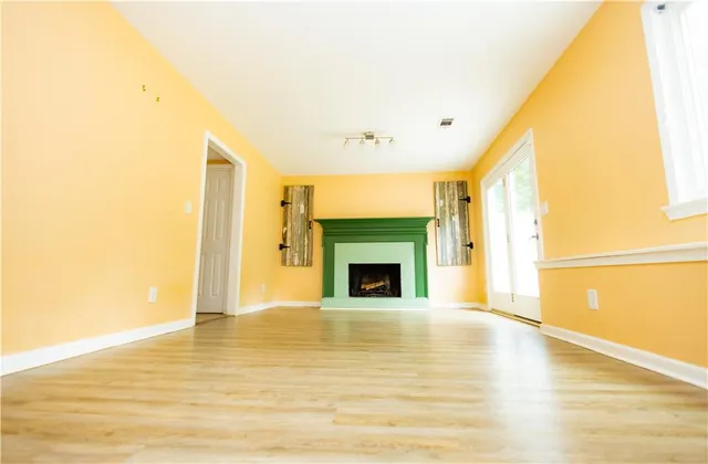a large kitchen with granite countertop a sink and cabinets