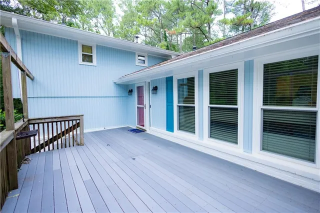 a view of backyard with deck and wooden floor