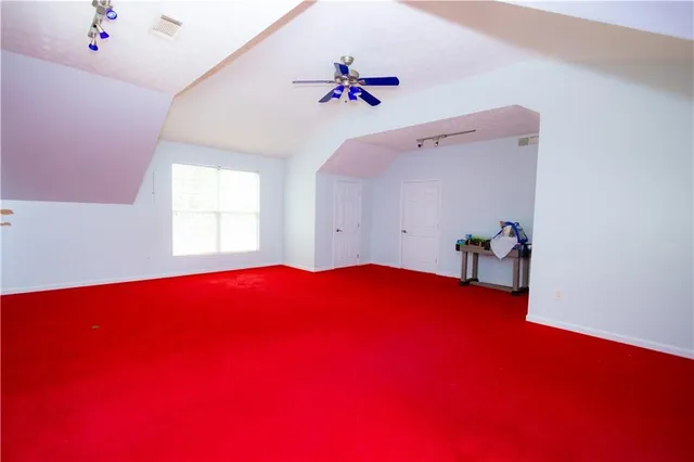a blue bed sitting in a bedroom next to a window