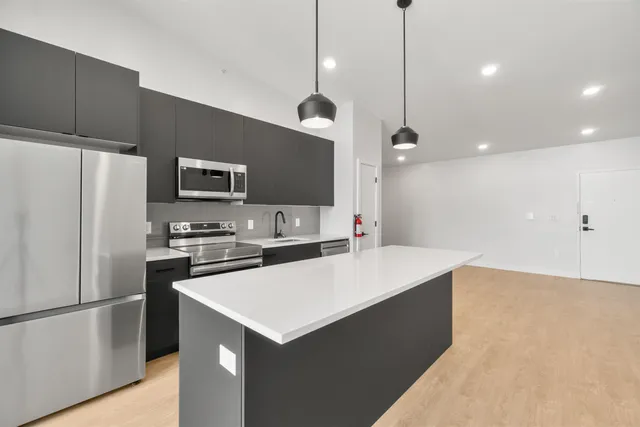 a kitchen with a refrigerator a sink and a stove