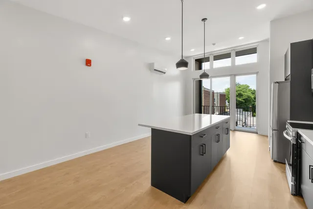 a kitchen with stainless steel appliances granite countertop a sink a refrigerator and a stove