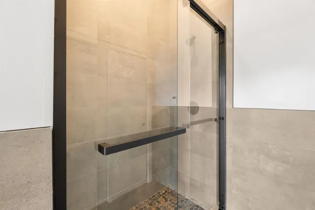 a bathroom with a glass shower door