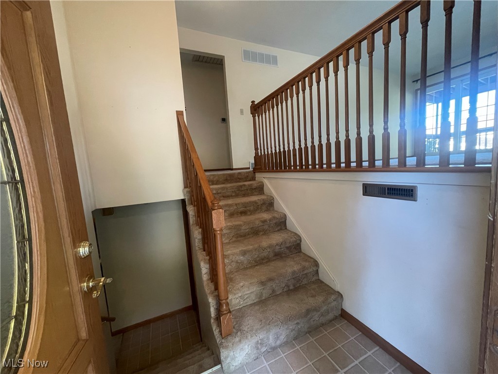 3707 River Road Vienna, WV 26105 - Photo 6 of 35 Stairway with tile patterned floors