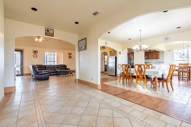 a view of a dining room with furniture and chandelier