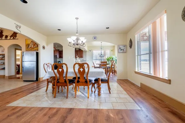 a view of a dining room with furniture and chandelier