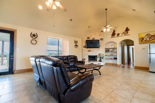 a view of a hallway with wooden floor and a bathroom
