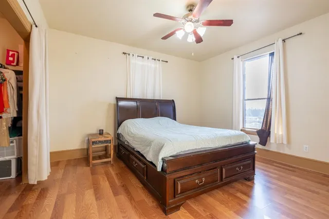 a bathroom with a granite countertop sink a toilet and shower