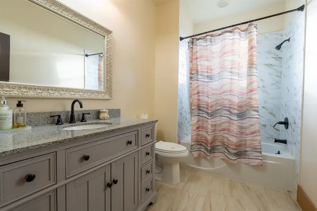 a bedroom with a bed and a potted plant