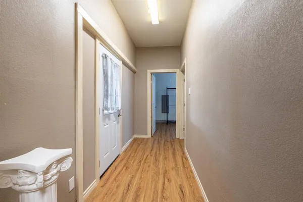 a very nice looking room with wooden floor and a window