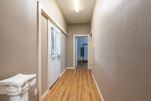 a very nice looking room with wooden floor and a window