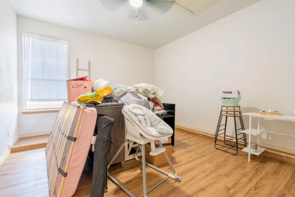 a view of a patio with a table and chairs and couches with wooden fence