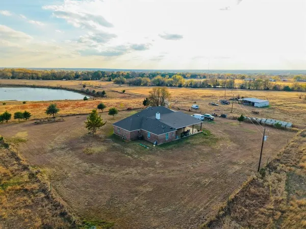 an aerial view of a house with swimming pool and ocean view