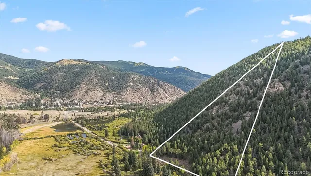 a view of a lush green hillside and a building