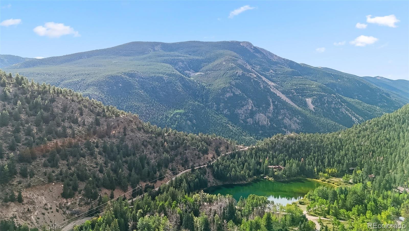 0 Bard Creek Road Empire, CO 80438 - Photo 7 of 21 a view of a lush green hillside and a building