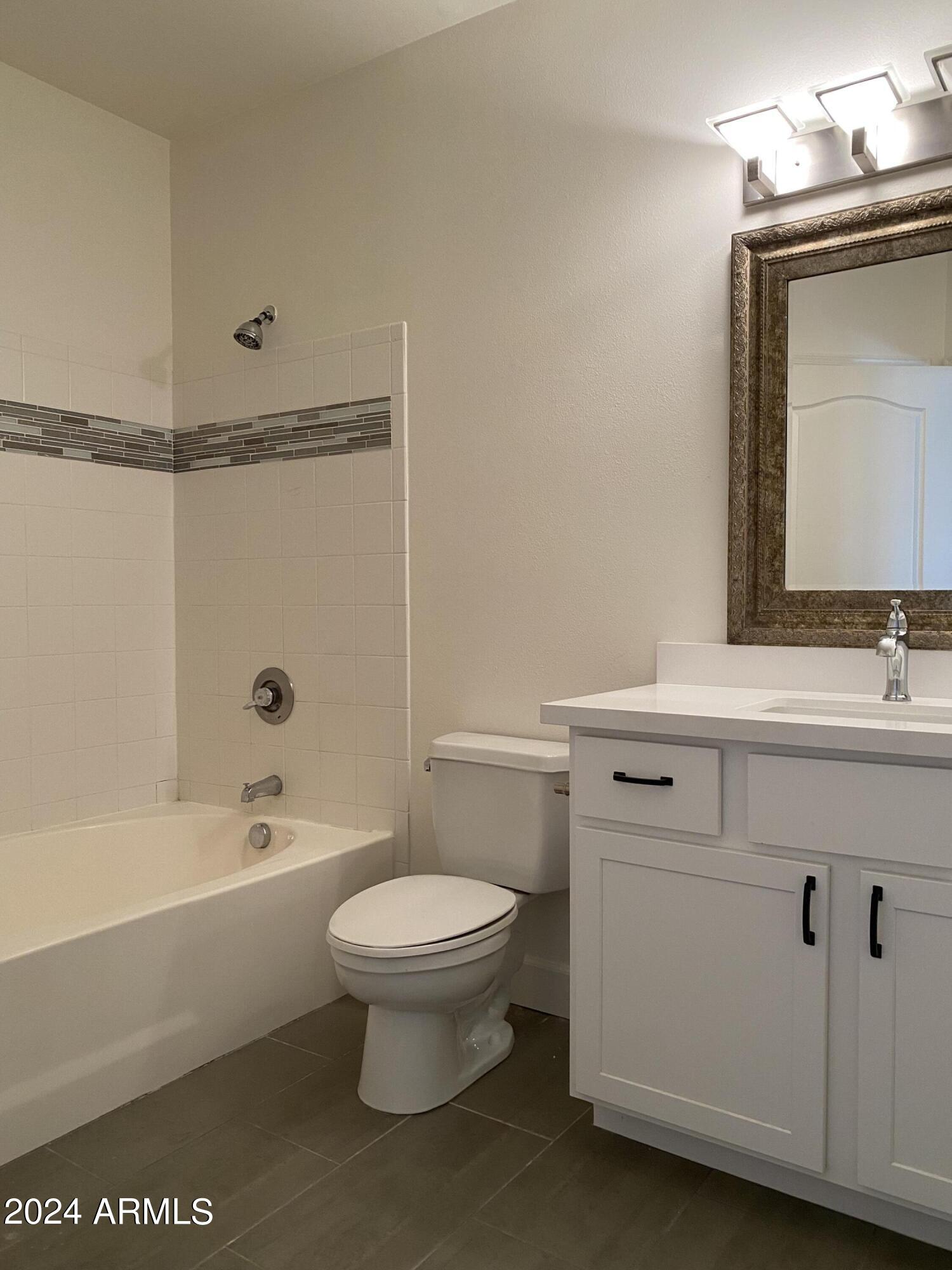 1701 East Colter Street, Unit 215 Phoenix, AZ 85016 - Photo 12 of 28 a bathroom with a sink toilet and shower