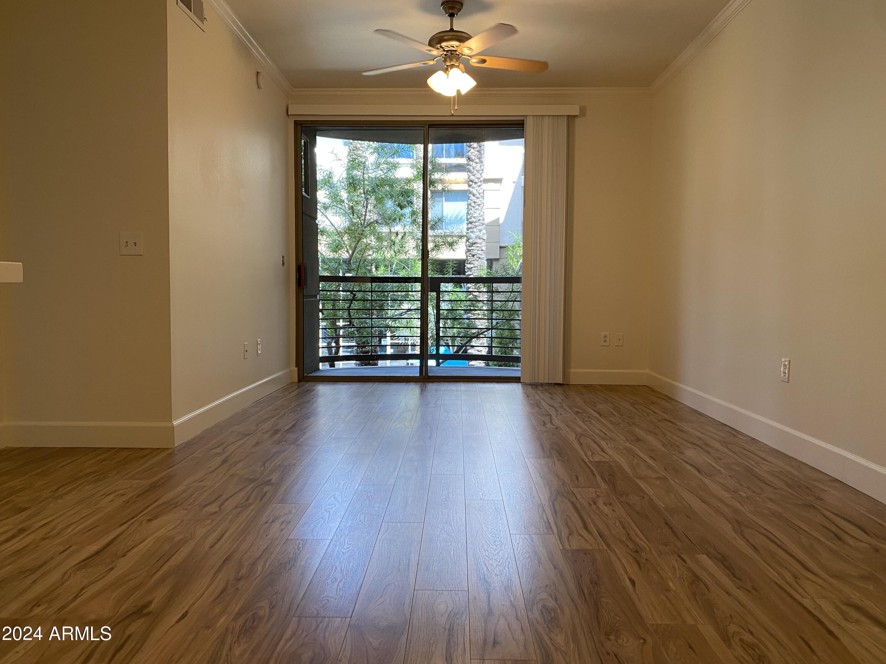 1701 East Colter Street, Unit 215 Phoenix, AZ 85016 - Photo 7 of 28 a view of a livingroom with wooden floor and a ceiling fan