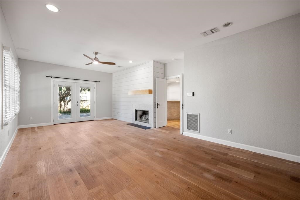 6 Sunview Road The Hills, TX 78738 - Photo 7 of 19 a view of an empty room with wooden floor and a window