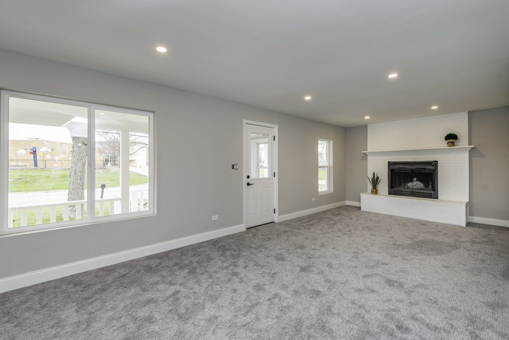 24199 West Beach Grove Road Antioch, IL 60002 - Photo 11 of 22 an empty room with windows and fireplace