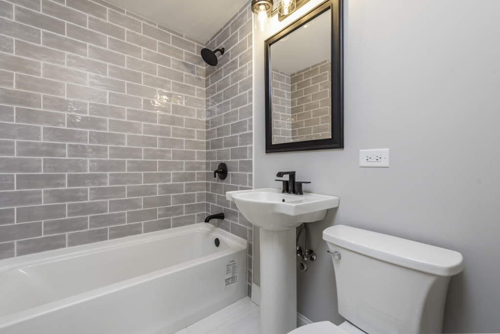 24199 West Beach Grove Road Antioch, IL 60002 - Photo 14 of 22 a bathroom with a sink a toilet and a bathtub