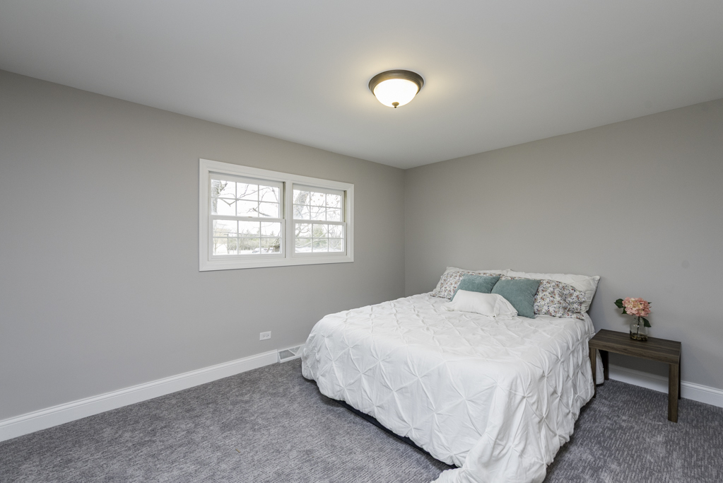 24199 West Beach Grove Road Antioch, IL 60002 - Photo 15 of 22 a bedroom with a bed and a window