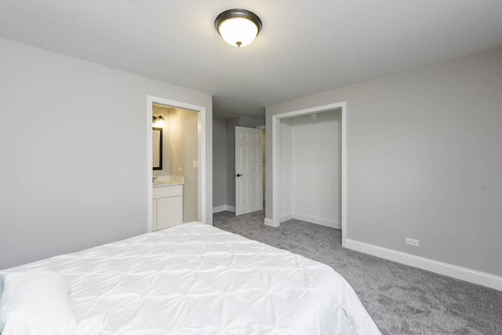 24199 West Beach Grove Road Antioch, IL 60002 - Photo 16 of 22 a bedroom with a bed and a dresser