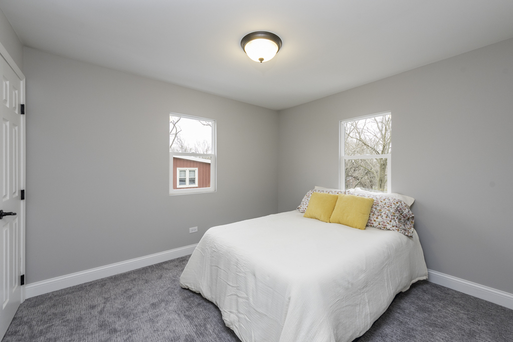 24199 West Beach Grove Road Antioch, IL 60002 - Photo 19 of 22 a bedroom with a bed and a window