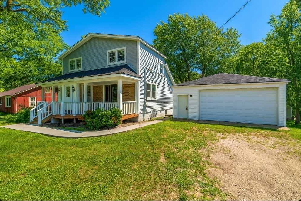 24199 West Beach Grove Road Antioch, IL 60002 - Photo 2 of 22 a front view of a house with a yard and garage