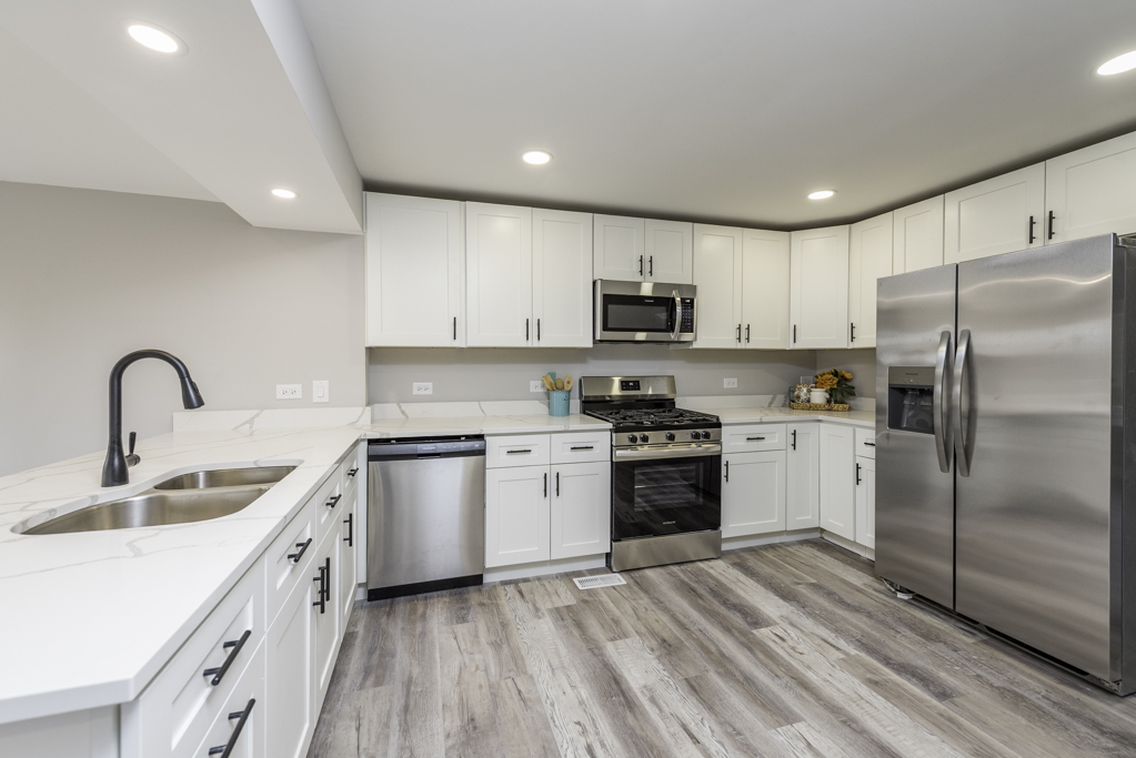 24199 West Beach Grove Road Antioch, IL 60002 - Photo 4 of 22 a kitchen with kitchen island a sink stainless steel appliances and cabinets