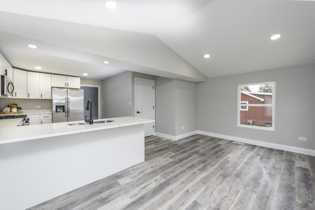 24199 West Beach Grove Road Antioch, IL 60002 - Photo 7 of 22 a kitchen with stainless steel appliances a sink and a refrigerator