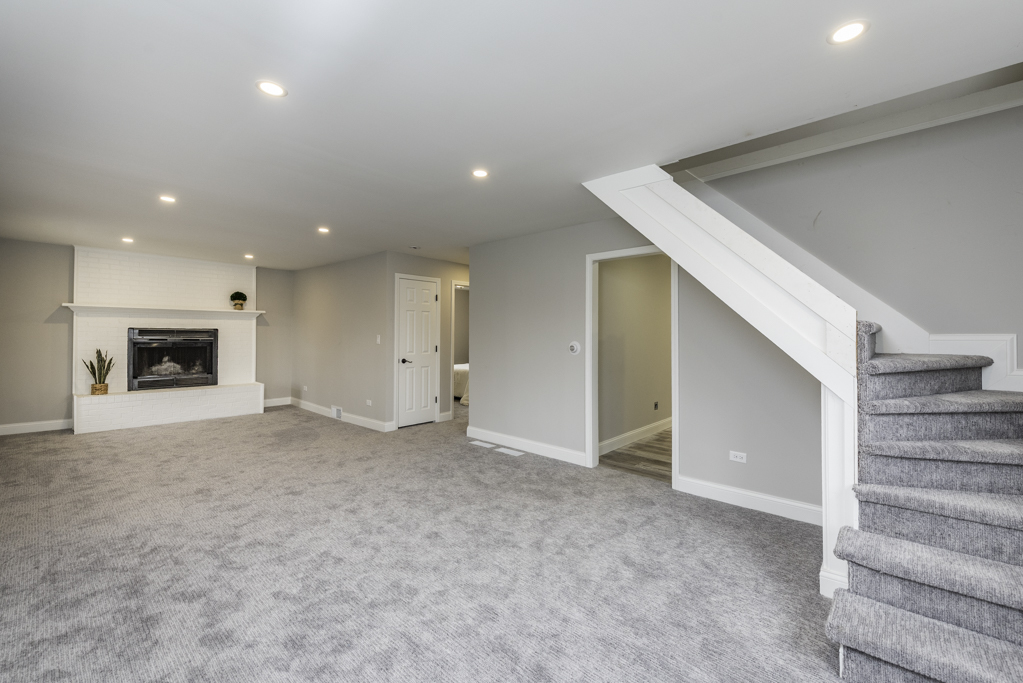 24199 West Beach Grove Road Antioch, IL 60002 - Photo 10 of 22 a view of an empty room with a fireplace and a window
