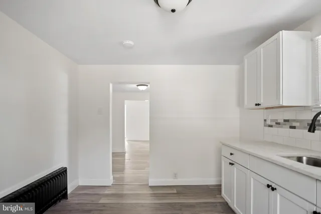 a view of a kitchen with sink and cabinets